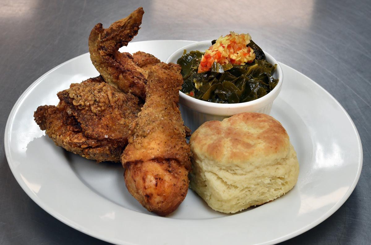 Fried chicken leg and thigh, cane creek farm collards, chow chow, country biscuit at the Village Diner in Hillsborough, N.C. Thursday, Oct.18, 2018.