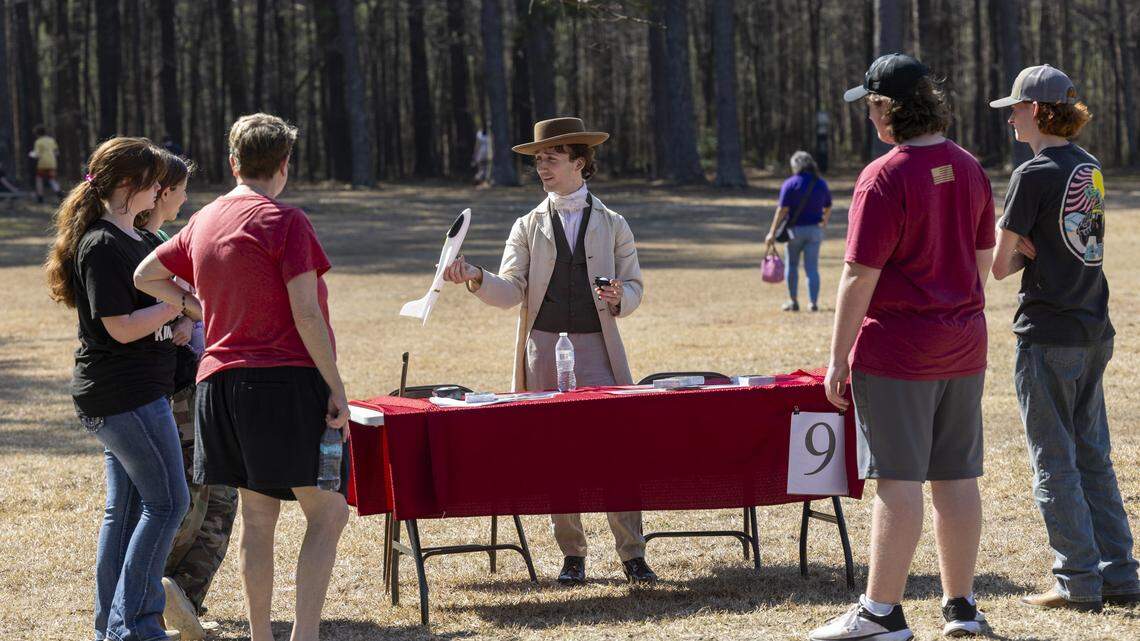 Dakota Sheets, a site interpreter, leads an educational station during a homeschool day event at Bennett Place State Historic Site in Durham on Friday. 