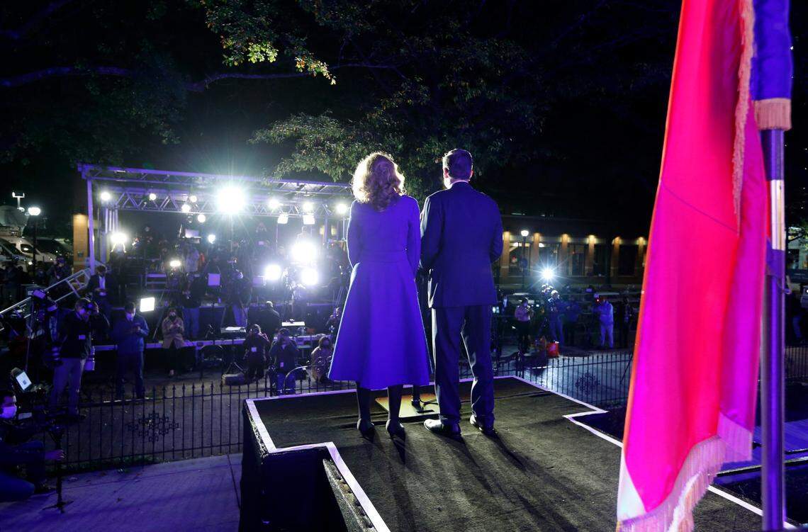 Gov. Roy Cooper, standing with his wife Kristin, speaks outside the North Carolina Democratic Party headquarters in Raleigh, N.C., Tuesday, Nov. 3, 2020.