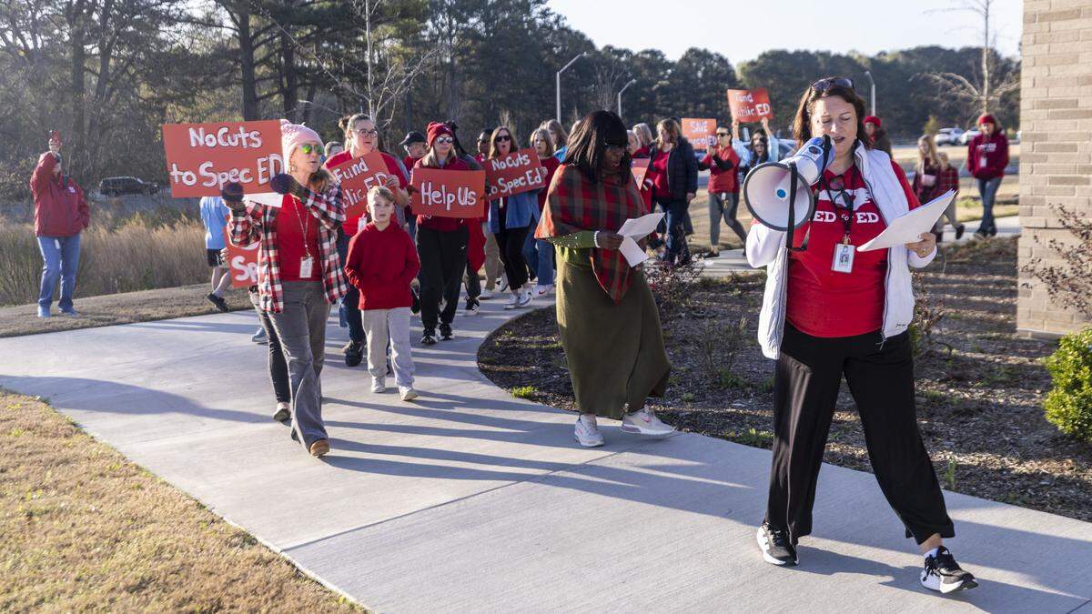 Educators and parents picket outside Fuquay-Varina Elementary School on Thursday, March 19, 2026, urging Wake County school leaders to prevent budget cuts that would reduce spending on special education programs.