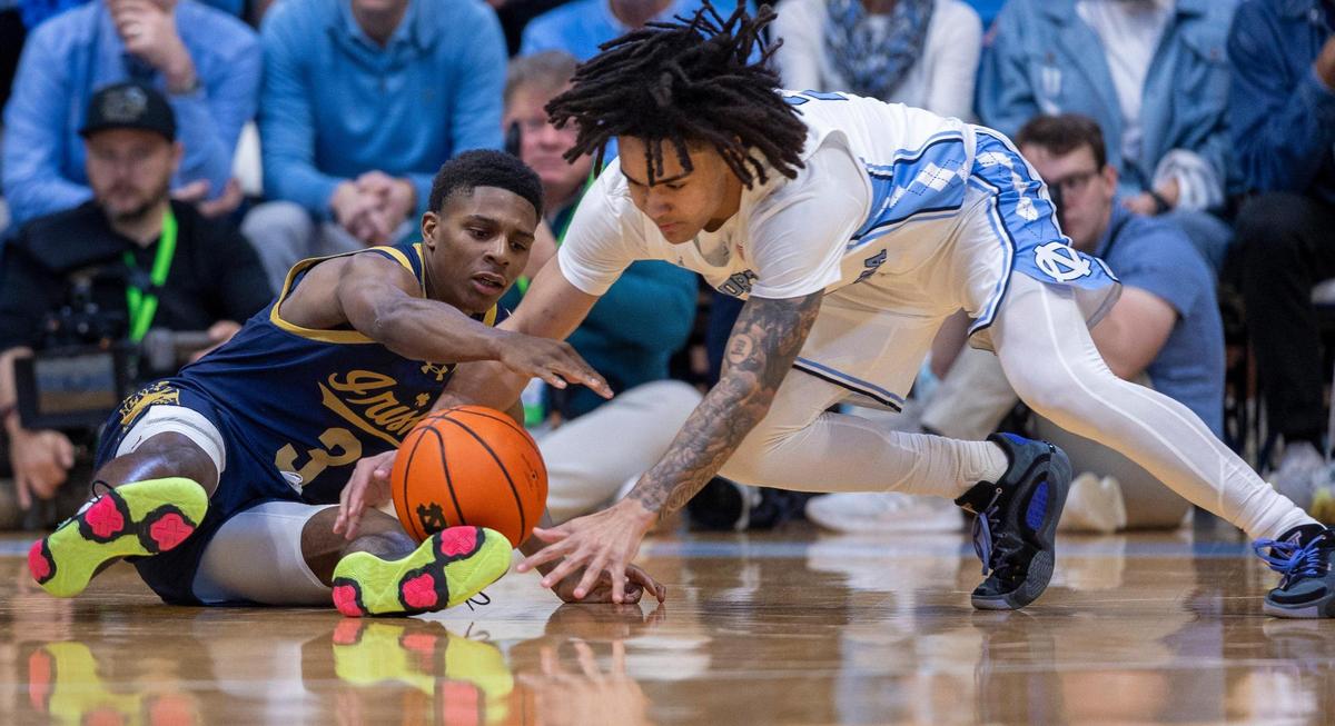 North Carolina’s Elliot Cadeau (2) goes after a loose ball with Notre Dame’s Markus Burton (3) during the first half on Tuesday, March 5, 2023 at the Smith Center in Chapel Hill, N.C.