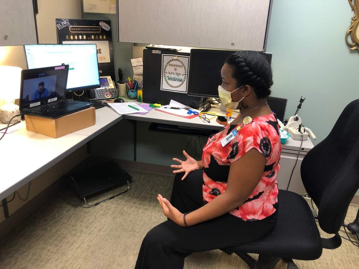 Heather Davis, a voice therapist at UNC, teaches breathing exercises to new patient Alyx Ashby of Newton to help Ashby recover from long COVID-19.  