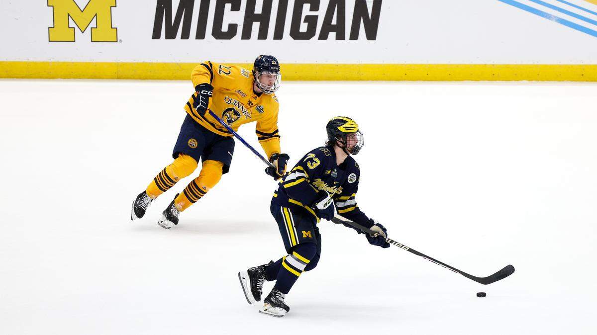 Michigan defenseman Ethan Edwards (73) controls the puck from Quinnipiac forward Skyler Brind’Amour (22) during the second period in the semifinals of the 2023 Frozen Four college ice hockey tournament at Amalie Arena. Quinnipiac won the game. In the final, Brind’Amour was a key player on the tying goal against Minnesota as the Bobcats won their first national title.