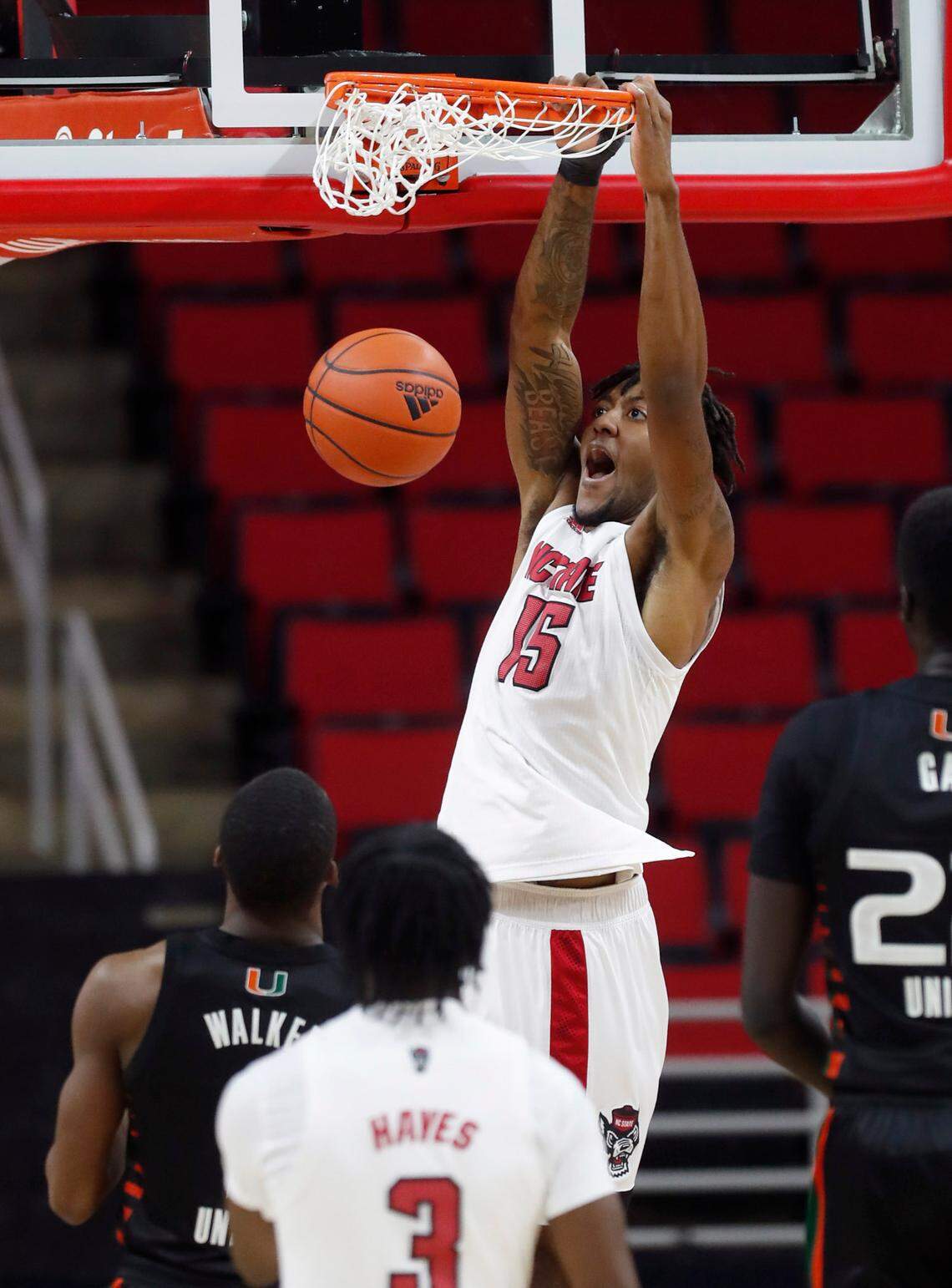 N.C. State’s Manny Bates (15) slams in two during the first half of N.C. State’s game against Miami at PNC Arena in Raleigh, N.C., Saturday, January 9, 2021.
