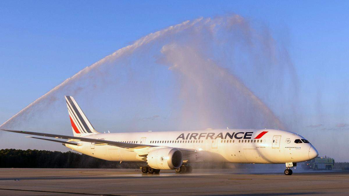 The first Air France flight from Paris at Raleigh-Durham International Airport taxis under water cannon spray after landing Oct. 30, 2023.