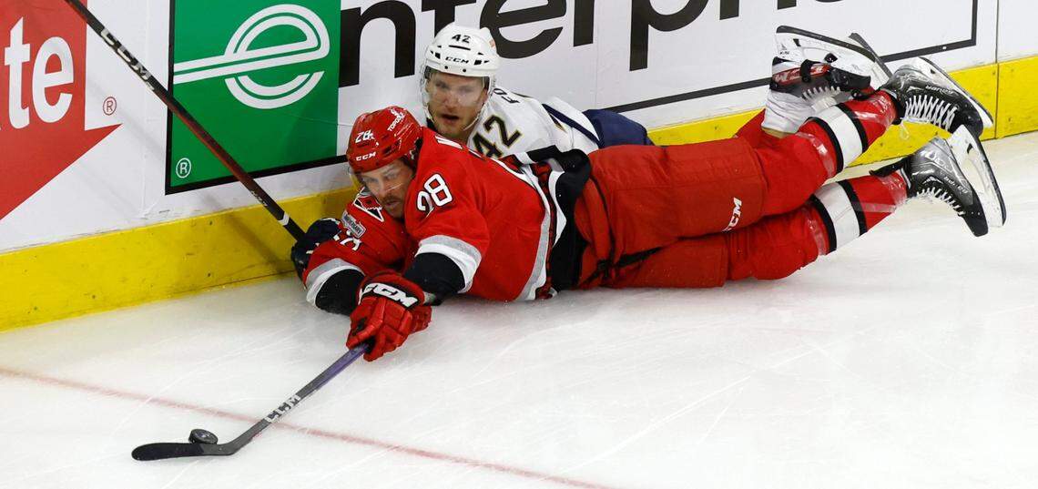 Carolina left wing Mackenzie MacEachern (28) keeps the puck from Florida defenseman Gustav Forsling (42) during the second period of game two between the Hurricanes and Panthers in the Eastern Conference Finals at PNC Arena in Raleigh, N.C., Saturday, May 20, 2023.