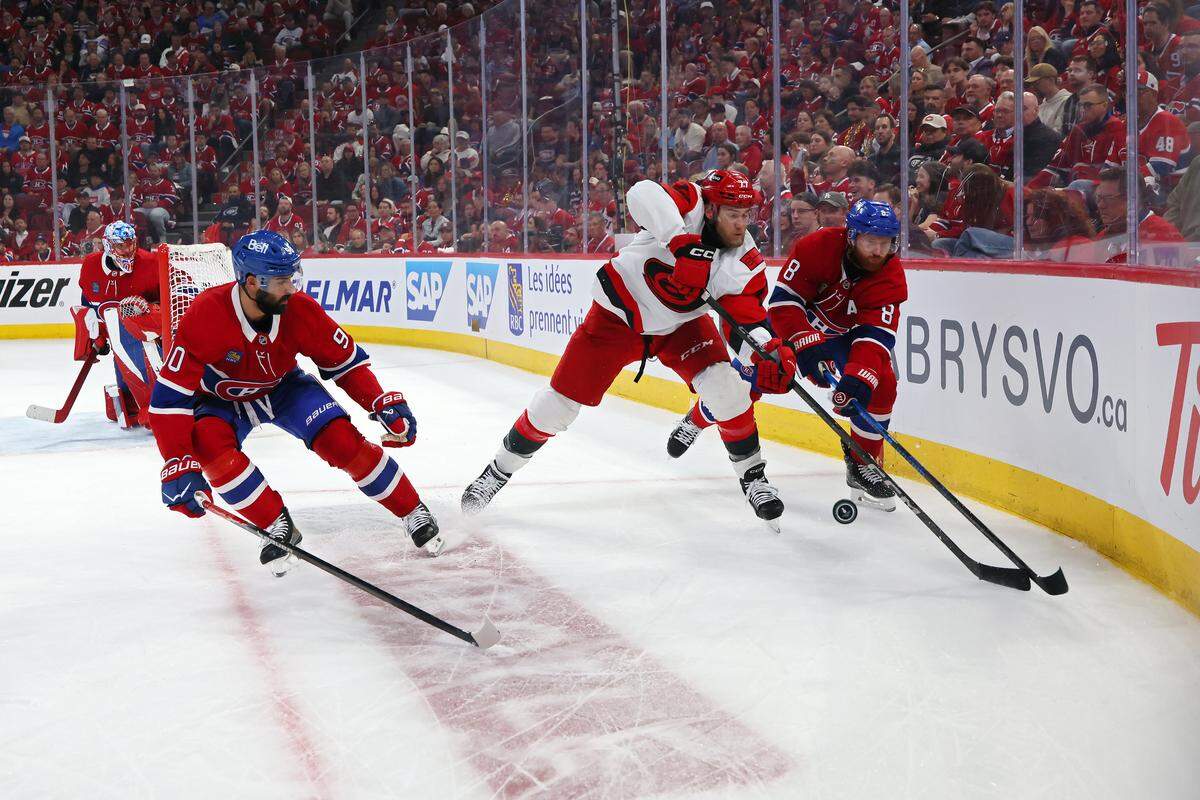 Mark Jankowski #77 of the Carolina Hurricanes and Mike Matheson #8 of the Montreal Canadiens compete for the puck during the third period in Game Four of the Eastern Conference Final of the 2026 Stanley Cup Playoffs at Bell Centre on May 27, 2026 in Montreal, Quebec, Canada. 