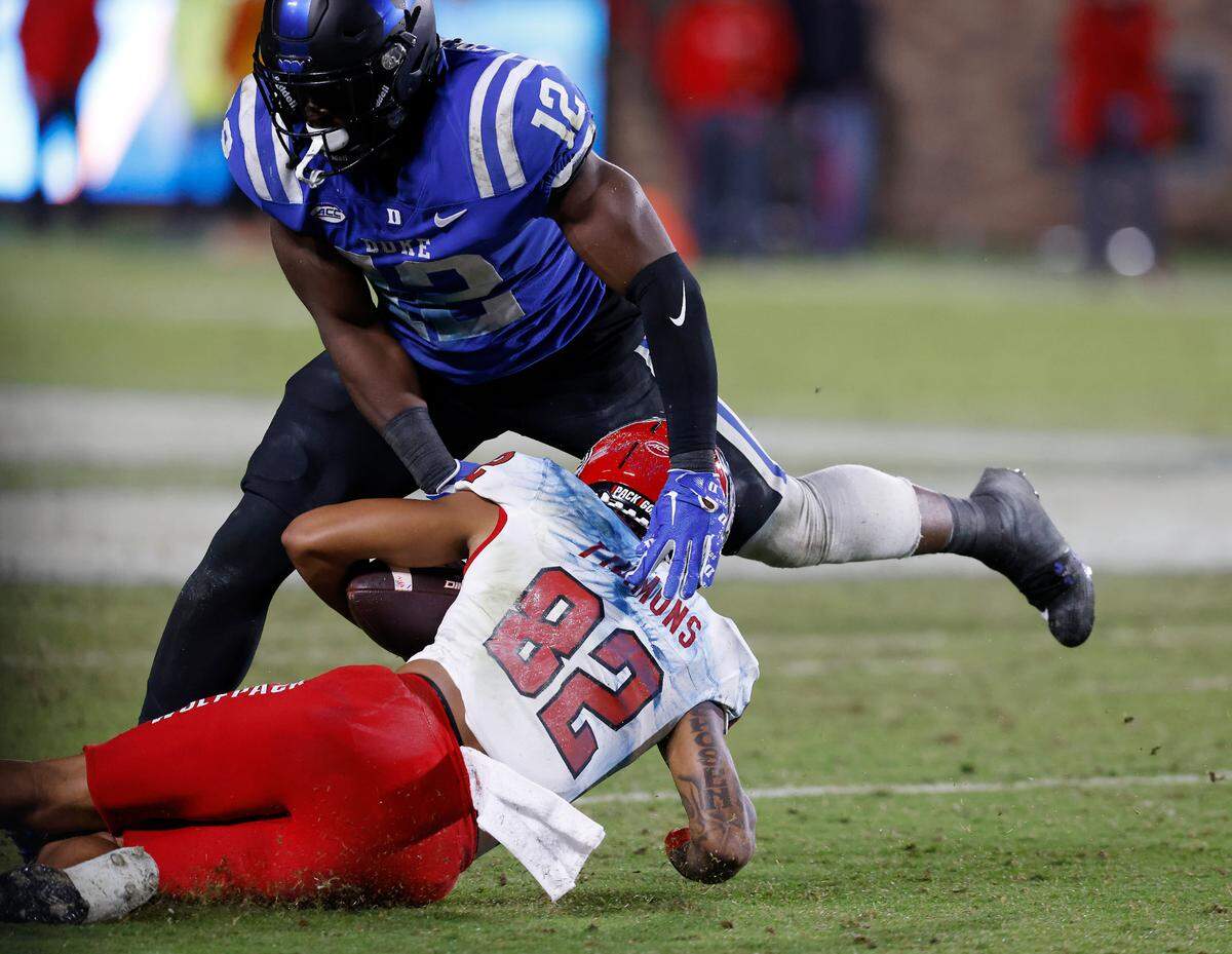 N.C. State’s Terrell Timmons Jr. slides past Duke’s Tre Freeman during the second half of the Blue Devils’ 24-3 win on Saturday, Oct. 14, 2023, at Wallace Wade Stadium in Durham, N.C.