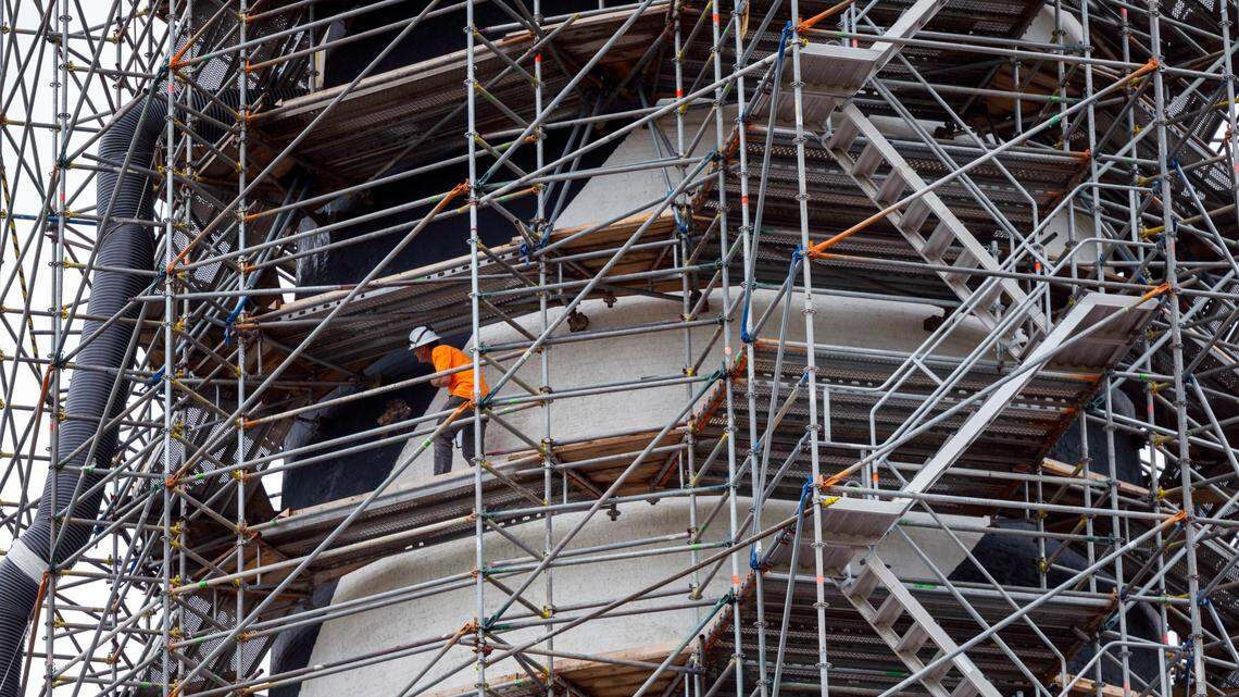 A worker navigates the scaffolding surrounding the Cape Hatteras Lighthouse during a restoration project on Monday, July 1, 2024. The project is expected to cost $19.2 million and will include replacing 40,000 of its estimated 1,250,000 bricks, replacing rusted or broken metal components and the installation of a near-exact replica of the first-order Fresnel lens.