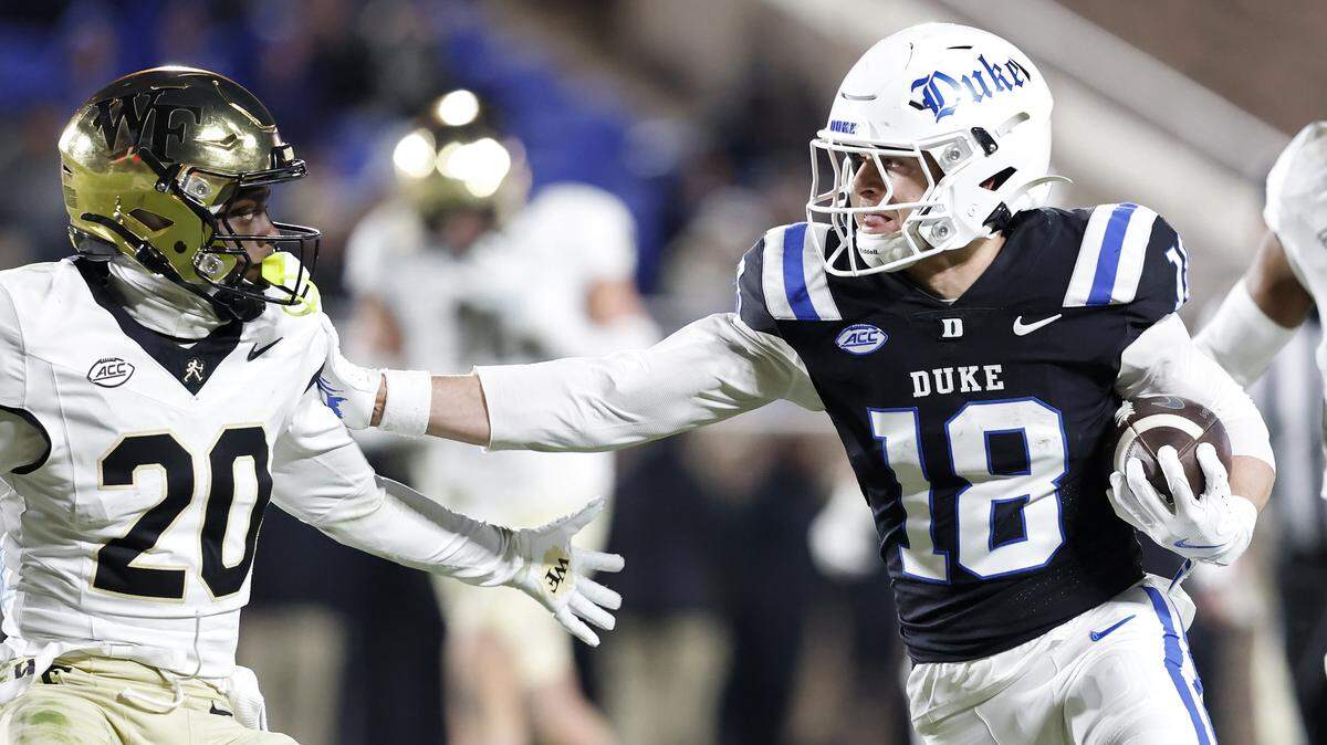 Duke’s Cooper Barkate runs the ball past Wake Forest’s Lardarius Webb Jr. during the second half of the Blue Devils’ 49-32 win on Saturday, Nov. 29, 2025, at Wallace Wade Stadium in Durham, N.C.
