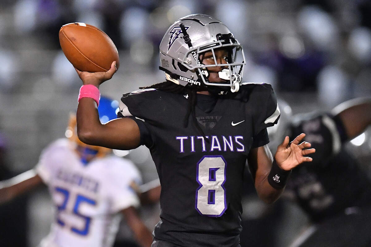 South Garner quarterback Chase Hardy (8) looks to pass downfield against Garner during the second half. The South Garner Titans and the Garner Trojans met in a conference football game in Raleigh, N.C. October 17, 2025