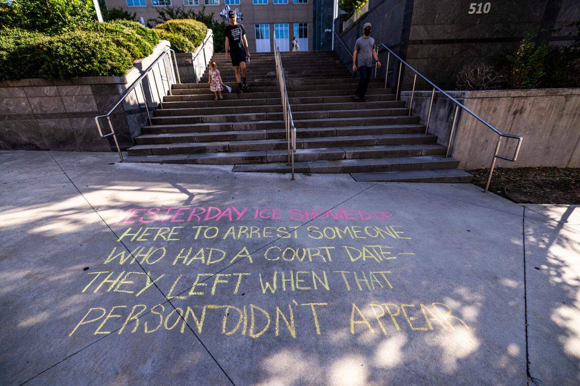 Chalk writing on a sidewalk outside the Durham County Courthouse warns passers-by that ICE officers were spotted at the courthouse on Wednesday, July 23, 2025, according to activists with Siembra NC. The advocacy group said U.S. Immigration and Customs Enforcement officers were there to detain a man who was scheduled to appear in court that day. The unidentified man did not show up.