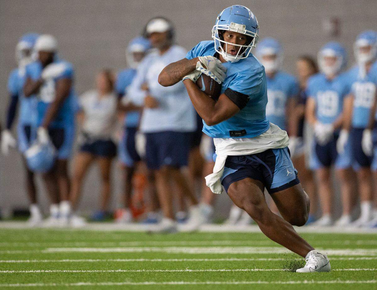 North Carolina running back Caleb Hood (4) carries the ball during the Tar Heels’ first day of practice on Wednesday, August 2, 2023 in Chapel Hill, N.C.