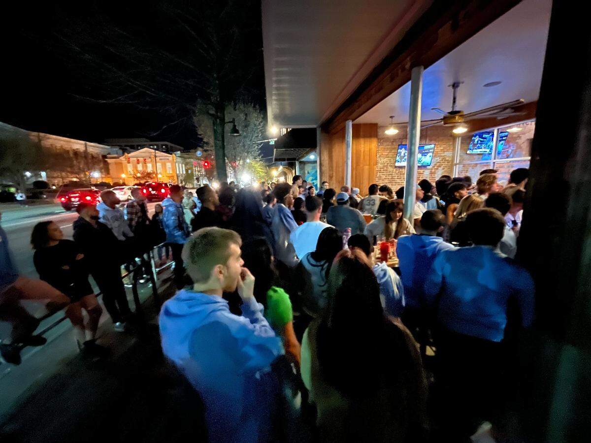 Fans watch the second half of the UNC-Duke game from outside Sup Dogs restaurant on Franklin Street in Chapel Hill.