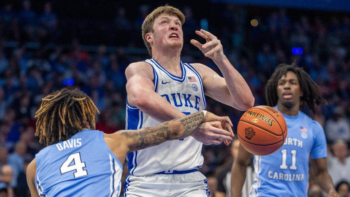 North Carolina guard R.J. Davis (4) tries to strip the ball from Duke’s Kon Knueppel (7) in the first half on Friday, March 14, 2025 during the semifinals of the ACC Tournament at Spectrum Center in Charlotte, N.C.