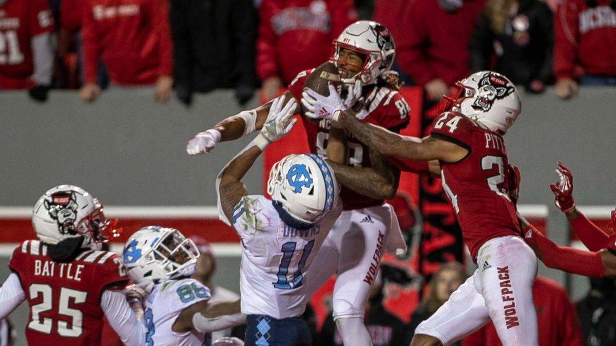 N.C. State Derrick Pitts (24) intercepts a Sam Howell pass on the final play of the game to secure the Wolfpack’s 34-30 victory over North Carolina on Friday, November 26, 2021 at Carter-Finley Stadium in Raleigh, N.C.