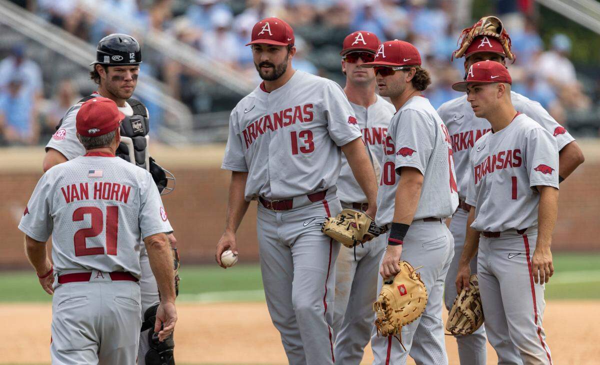 Arkansas coach Dave Van Horn takes starting pitcher Connor Noland (13) out of the game in the seventh inning against North Carolina during the first game of their Super Regional series on Saturday, June 11, 2022 at Boshamer Stadium in Chapel Hill, N.C. Noland struck out six and was credited with the 4-1 victory over North Carolina.