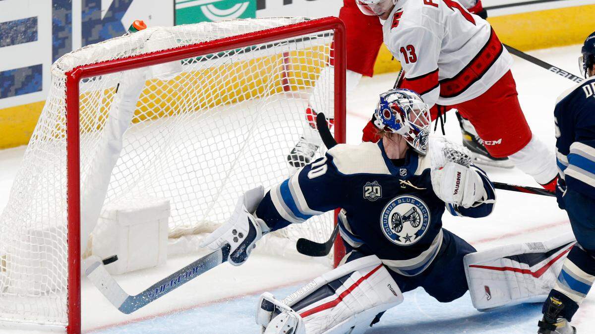 Carolina Hurricanes forward Warren Foegele, right, scores past Columbus Blue Jackets goalie Joonas Korpisalo during the second period of an NHL hockey game in Columbus, Ohio, Sunday, Feb. 7, 2021. (AP Photo/Paul Vernon)