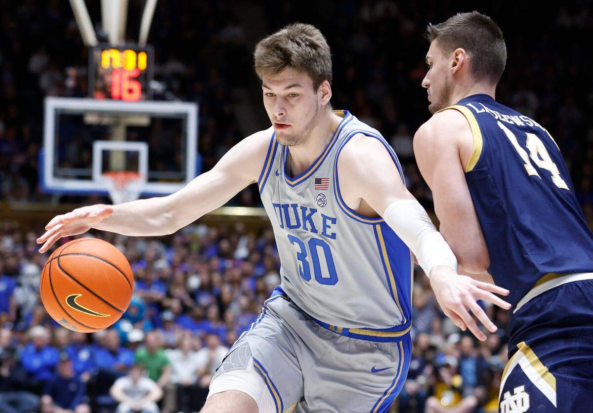 Duke’s Kyle Filipowski (30) drives around Notre Dame’s Nate Laszewski (14) during the first half of Duke’s game against Notre Dame at Cameron Indoor Stadium in Durham, N.C., Tuesday, Feb. 14, 2023.