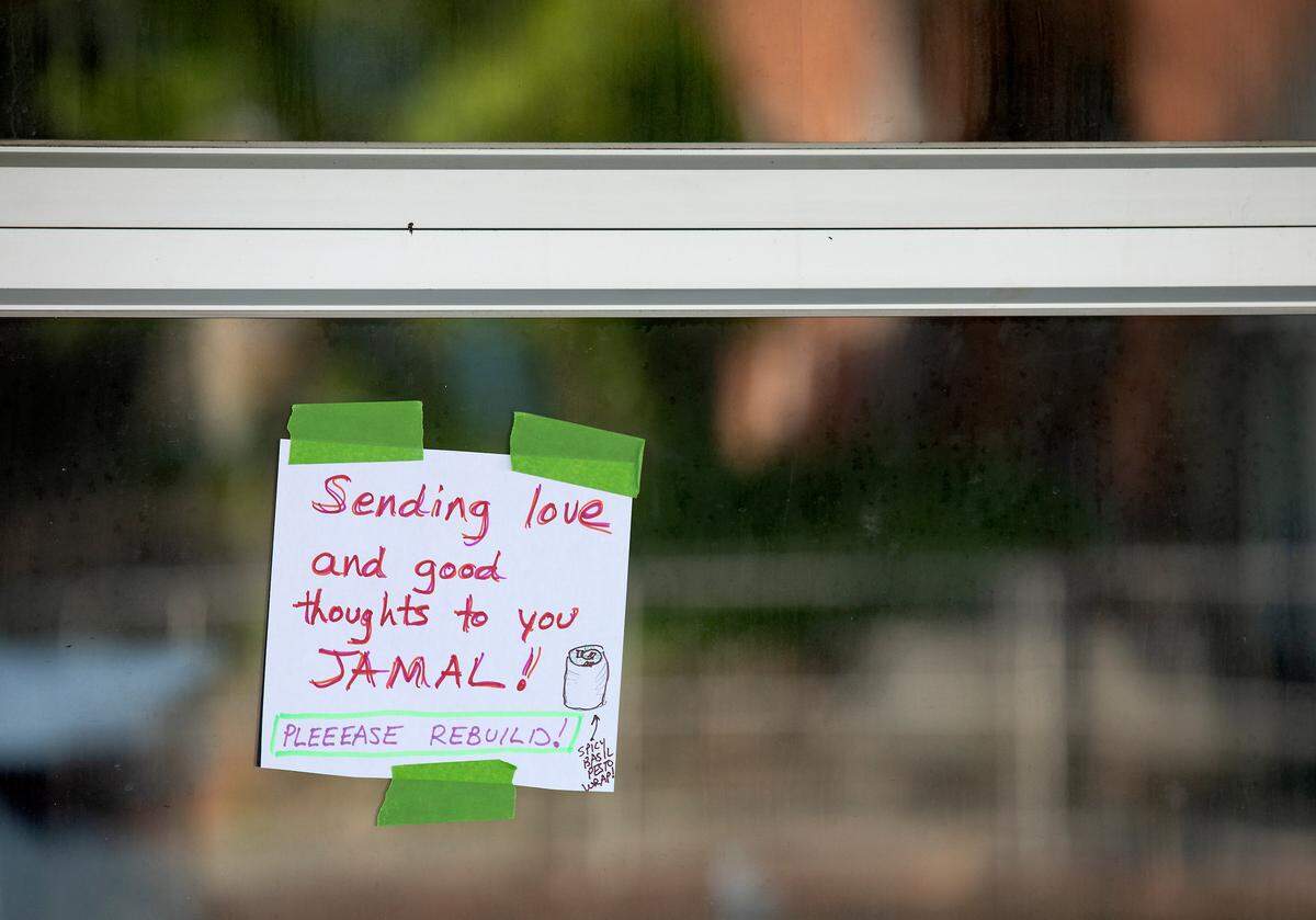 A note of support is posted outside Mediterranean Deli, Bakery and Catering on Monday, July 24, 2023, following a weekend fire that caused extensive damage at the Chapel Hill business.