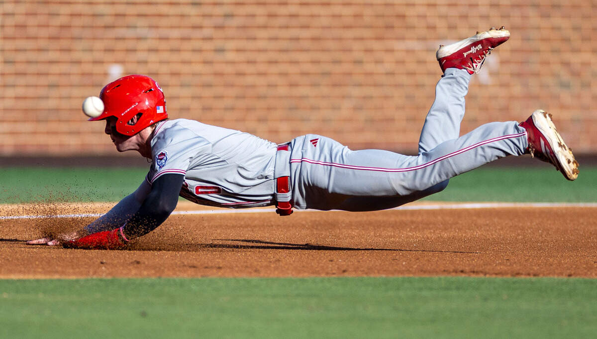 N.C. State infielder Luke Nixon (0) dives safely into third base ahead of the throw, on a single by Chris McHugh on Friday, May 9, 2025 at Boshamer Stadium in Chapel Hill, N.C.
