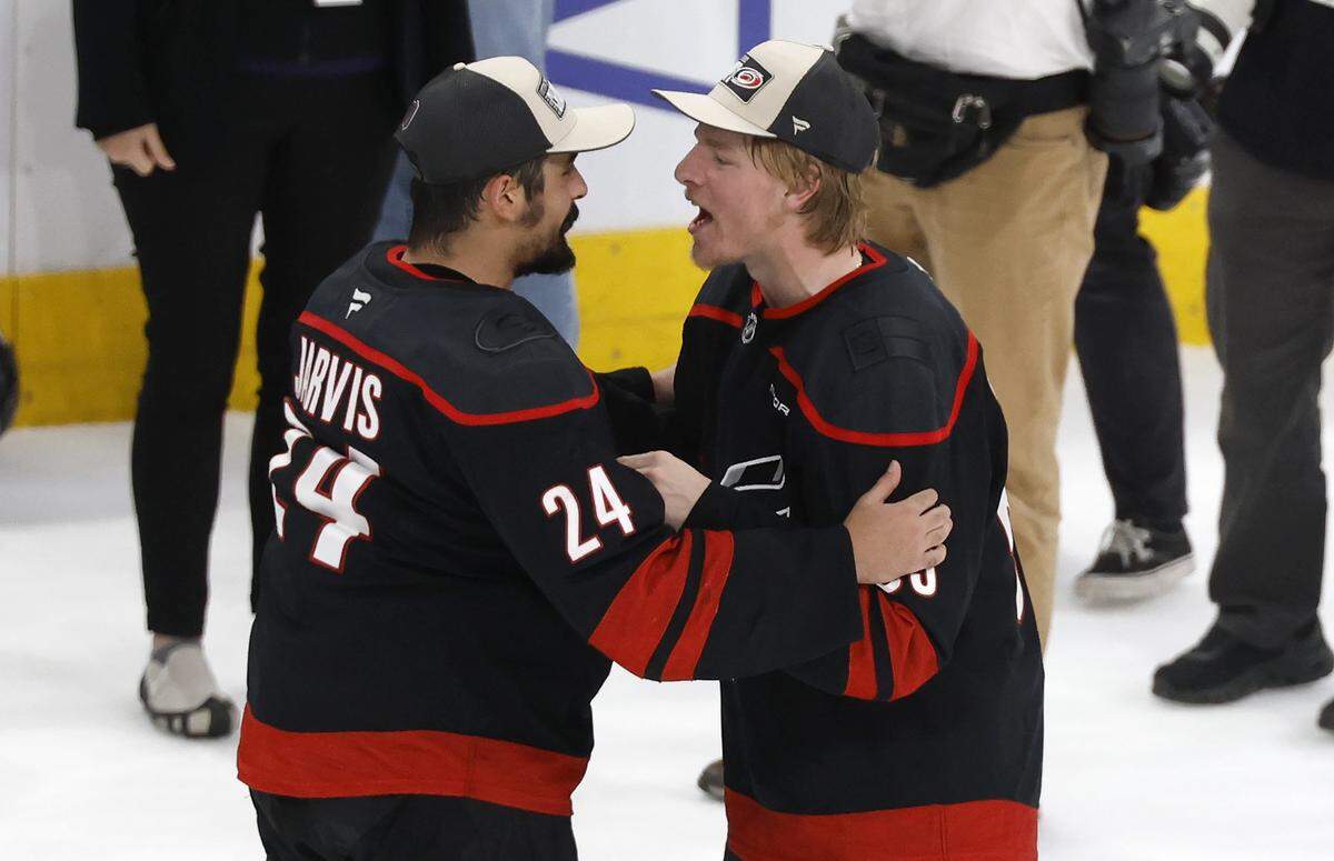 Carolina's Seth Jarvis (24) celebrates with Jackson Blake (53) after the Hurricanes’ 6-1 victory over the Canadiens in game five of the Eastern Conference Finals at the Lenovo Center Friday, May 29, 2026.