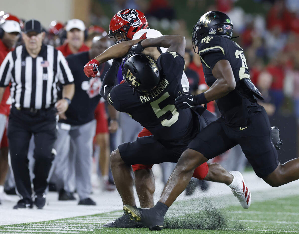 N.C. State running back Duke Scott (4) hits Wake Forest defensive back Davaughn Patterson (5) as he gains yards during the second half of N.C. StateÕs 34-24 victory over Wake Forest at Allegacy Stadium in Winston-Salem, N.C., Thursday, Sept. 11, 2025.