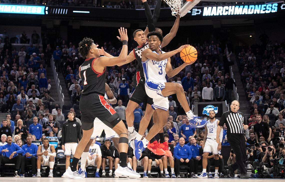 Dukes Jeremy Roach (3) passes out of the pressure by Texas Tech’s Kevin McCullar (15) and Terrence Shannon Jr. (1) during Dukes 78-73 victory over Texas Tech in the Sweet 16 round of the NCAA Tournament at the Chase Center in San Francisco, Calif., Thursday, March 24, 2022.