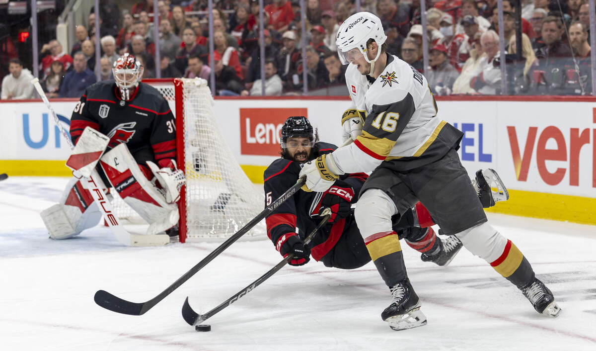 Carolina Hurricanes defenseman Jalen Chatfield (5) hits the ice as he defends Las Vegas right wing Pavel Dorofeyev (16) during the second period in Game 1 of the Stanley Cup Finals, on Tuesday, June 2, 2026 at Lenovo Center in Raleigh, N.C.