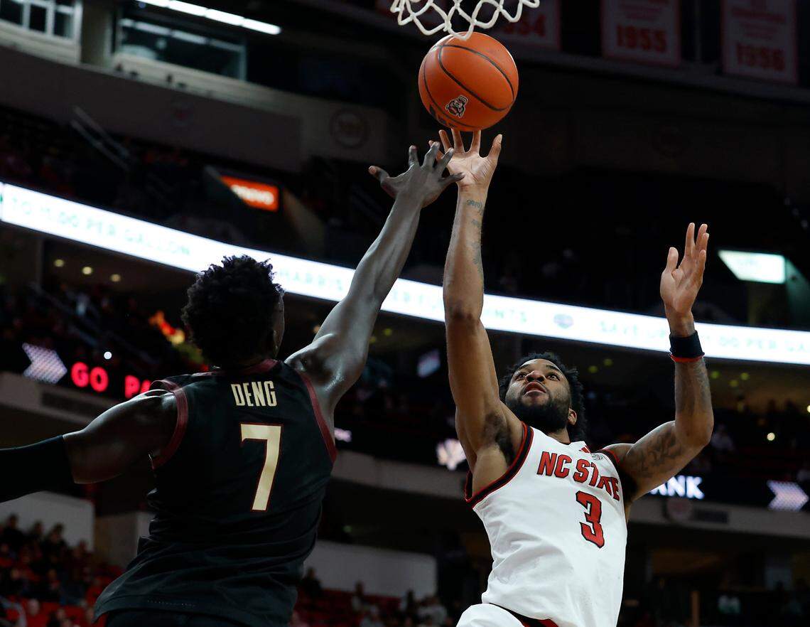 N.C. State’s Dontrez Styles shoots over Florida State’s Jerry Deng during the first half of the Wolfpack’s 84-74 overtime win on Saturday, Dec. 7, 2024, at Lenovo Center in Raleigh, N.C.