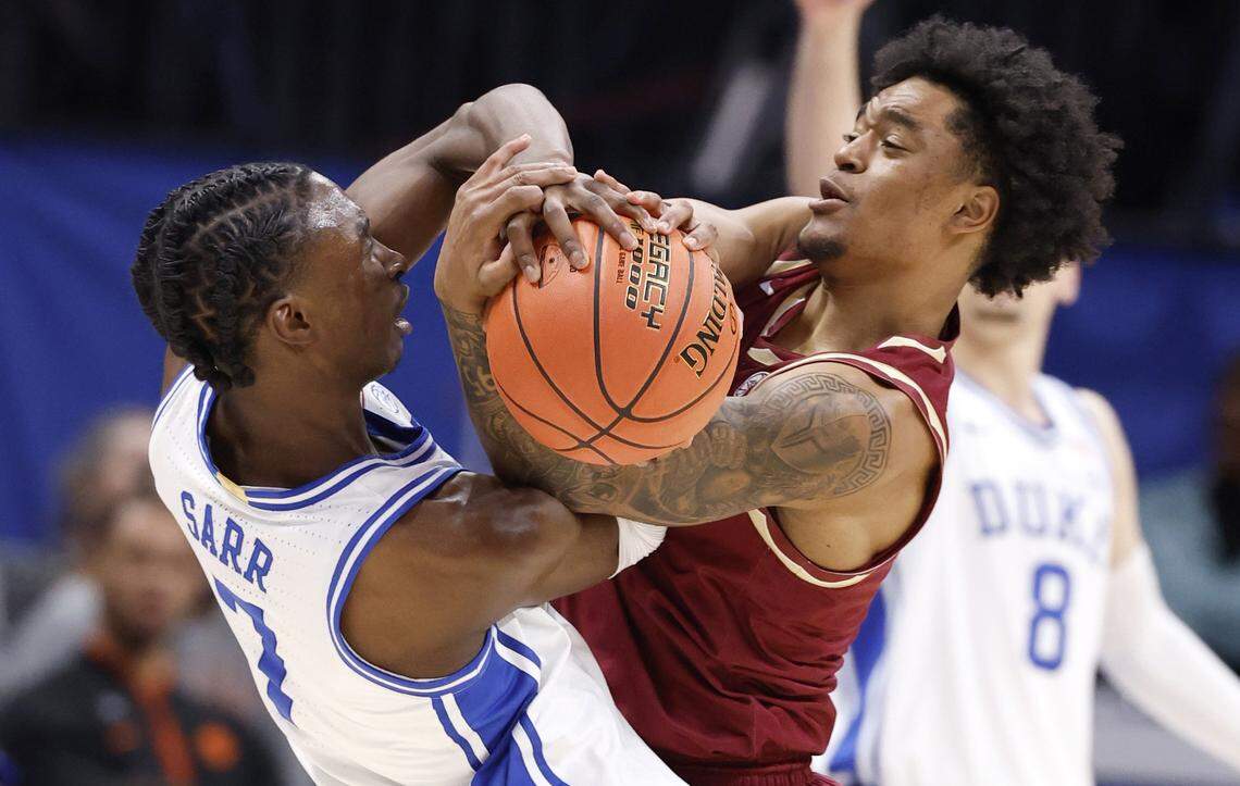 Duke’s Dame Sarr (7) is fouled while battling for the ball with Florida State's Martin Somerville (1) during the first half of Duke’s game against Florida State in the quarterfinals of the 2026 ACC Men’s Basketball Tournament at the Spectrum Center in Charlotte, N.C., Thursday, March 12, 2026.