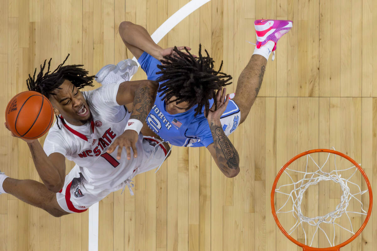 N.C. State’s Jayden Taylor (1) drives to the basket against North Carolina’s Elliot Cadeau (2) in the first half on Wednesday, January 10, 2024 at PNC Arena in Raleigh, N.C.