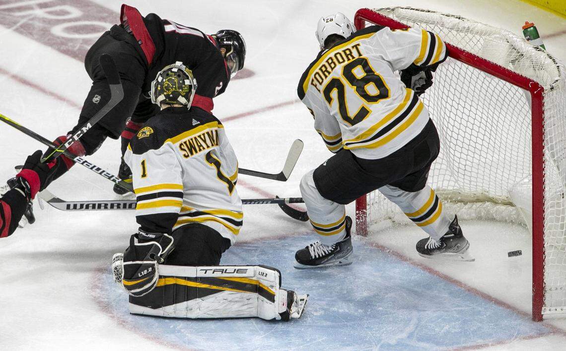 Carolina Hurricanes Seth Jarvis (24) scores on Boston Bruins goalie Jeremy Swayman (1) in the third period on Tuesday, May 10, 2022 during game five of their Stanley Cup first round series at PNC Arena in Raleigh, N.C.