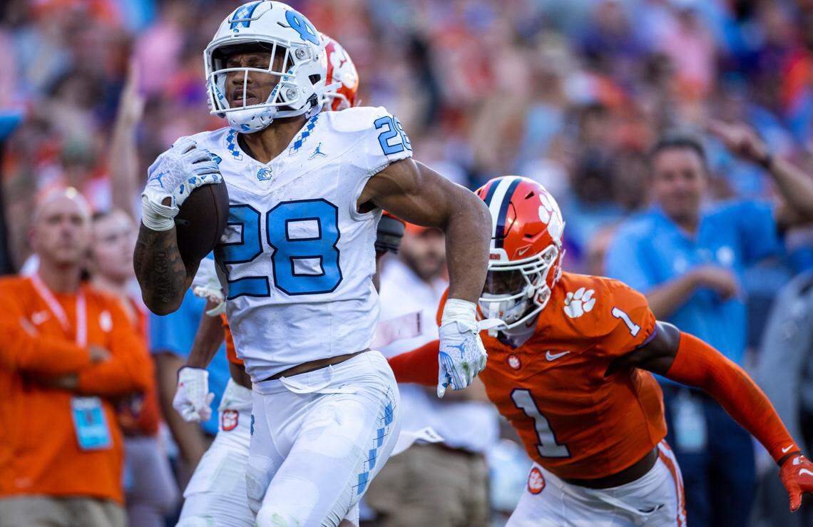 North Carolina’s Omarion Hampton (28) breaks open on a 64-yard run in the first quarter before having the ball stripped by Clemson’s Nate Wiggins (2) on Saturday, November 18, 2023 at Memorial Stadium in Clemson, S.C.