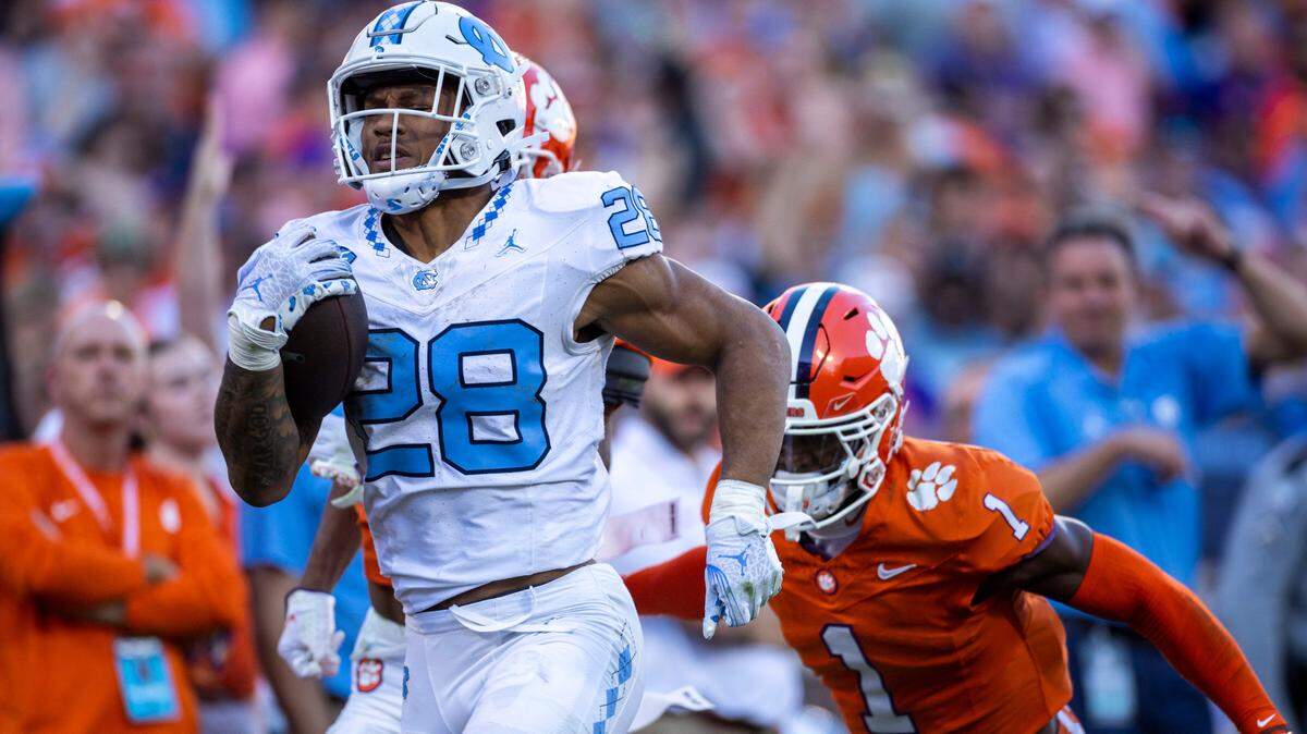 North Carolina’s Omarion Hampton (28) breaks open on a 64-yard run in the first quarter before having the ball stripped by Clemson’s Nate Wiggins (2) on Saturday, November 18, 2023 at Memorial Stadium in Clemson, S.C.