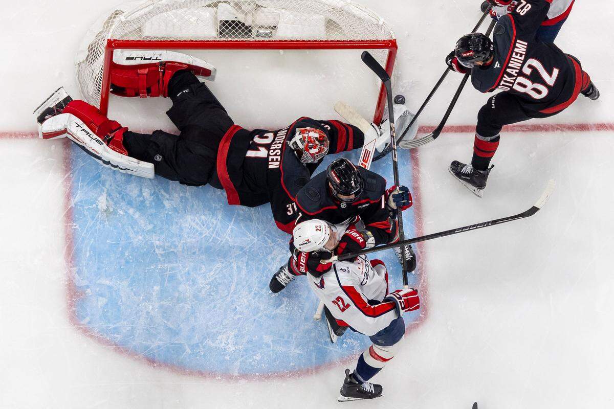 Carolina Hurricanes goalie Frederik Andersen (31) clears a scoring attempt by Washington Capitols left wing Anthony Beauvillier (72) in the first period during Game 3 of their series on Saturday, May 10, 2025 at Lenovo Center in Raleigh, N.C.