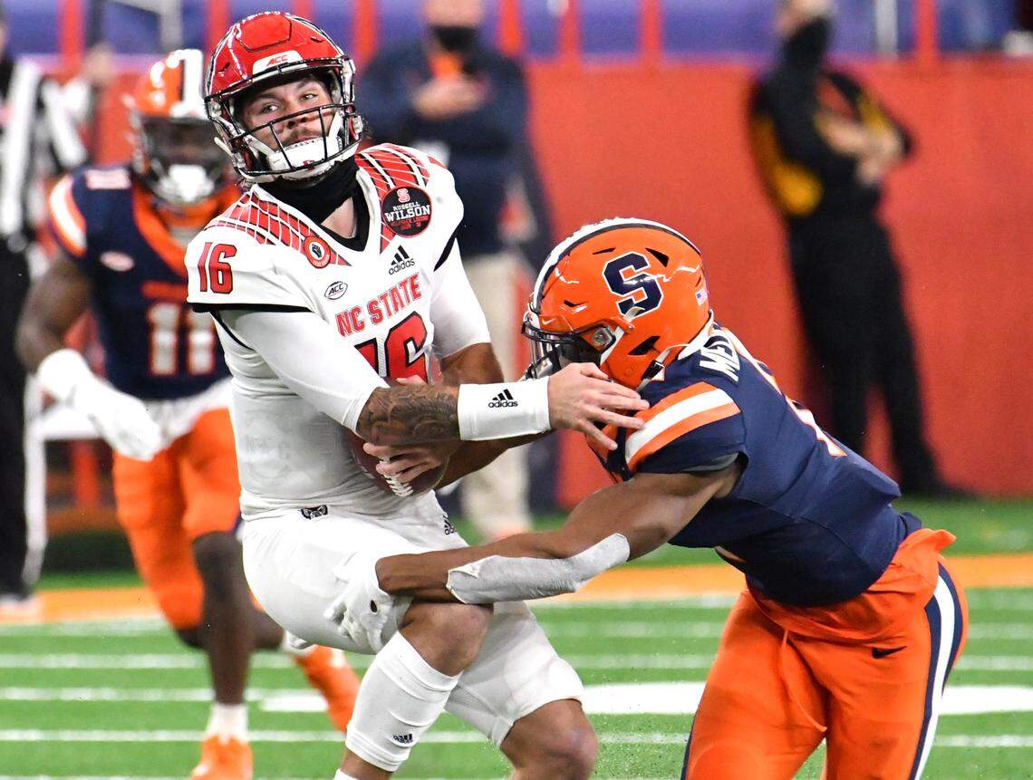 Nov 28, 2020; Syracuse, New York, USA;North Carolina State Wolfpack quarterback Bailey Hockman (16) is sacked by Syracuse Orange defensive back Ifeatu Melifonwu (2) in the second quarter at the Carrier Dome.