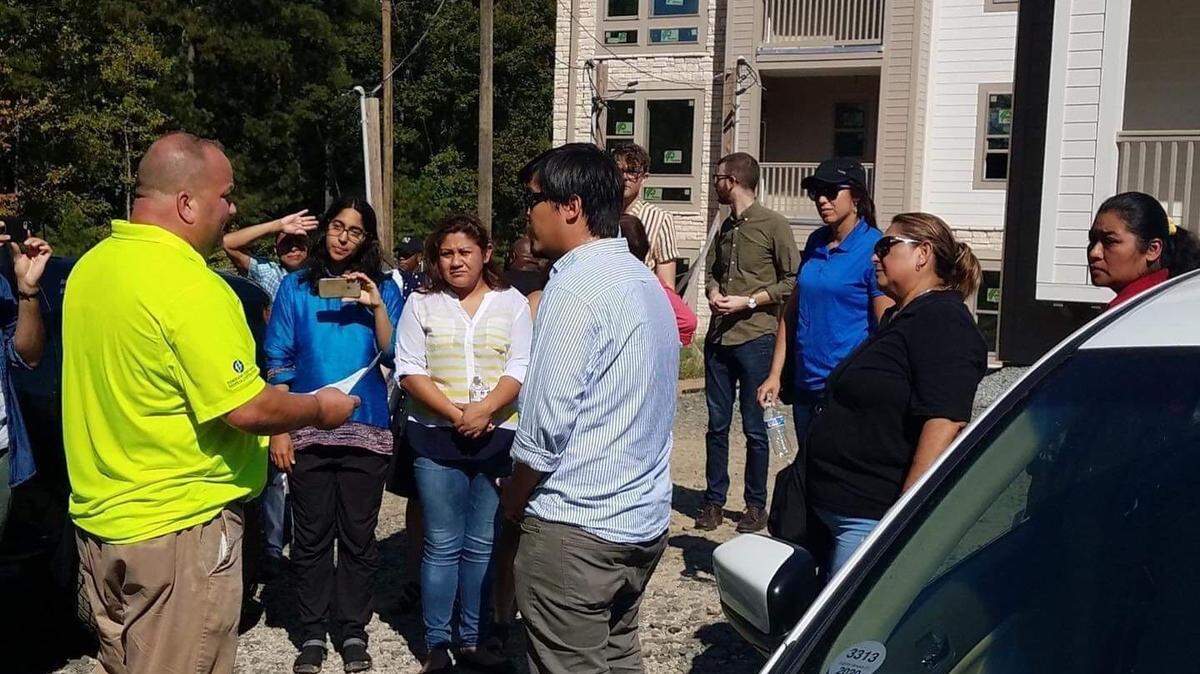 Workers deliver a letter demanding unpaid wages to a person on a work site belonging to their former employer.