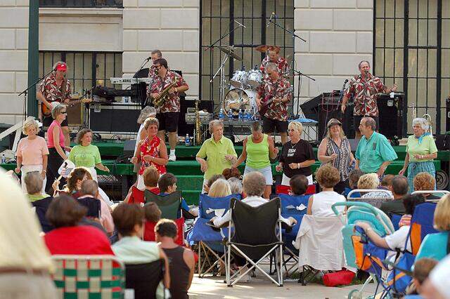 The Band Of Oz performs as line dancers entertain the crowd at the Old Courthouse in Concord in July 2004.