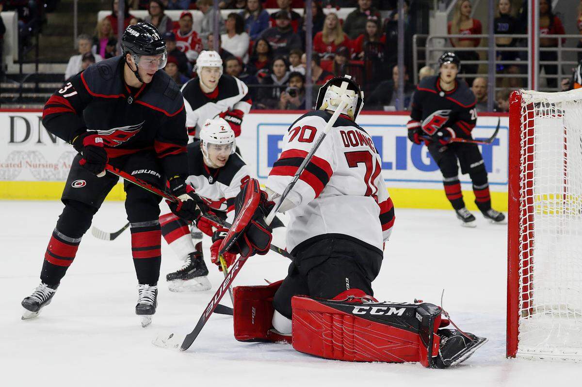 Carolina Hurricanes’ Andrei Svechnikov (37), of Russia, deflects the puck past New Jersey Devils goaltender Louis Domingue (70) during the second period of an NHL hockey game in Raleigh, N.C., Friday, Feb. 14, 2020. (AP Photo/Karl B DeBlaker)