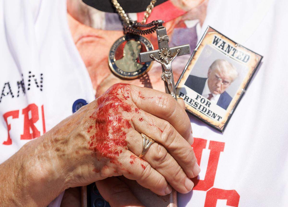Julianna Balogh prays at the start of a rally in support of former President and current Republican candidate for president Donald Trump in Wilmington, N.C. on Saturday, Sept. 21, 2024.