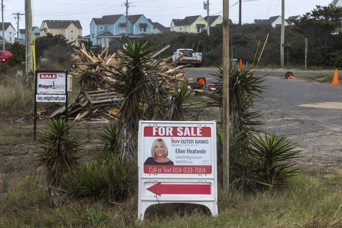 Debris from beach homes that collapsed into the Atlantic Ocean is piled along Old Lighthouse Road for removal in Buxton on Friday.