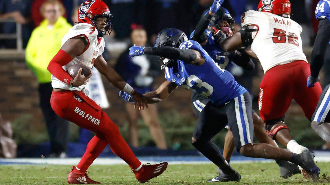 N.C. State quarterback MJ Morris (7) tries to escape from Duke safety Terry Moore (23) during the second half of Duke’s 24-3 victory over N.C. State at Wallace Wade Stadium in Durham, N.C., Saturday, Oct. 14, 2023.