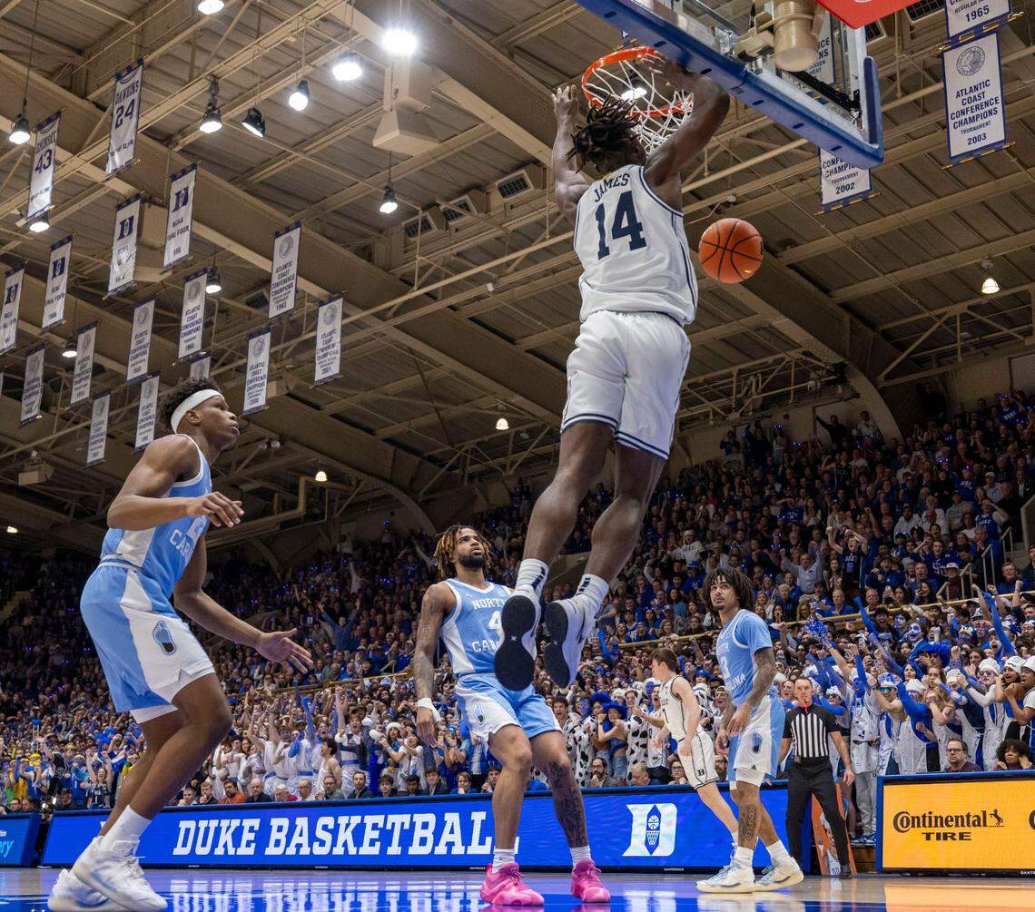 Duke guard Sion James (14) breaks to the basket for a dunk over North Carolina’s Ven-Allen Lubin (22), R.J. Davis (4) and Elliot Cadeau (3) to give the Blue Devils a 2-0 lead on Saturday, February 1, 2025 at Cameron Indoor Stadium in Durham, N.C.