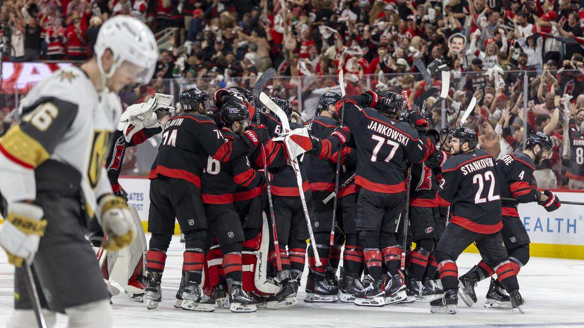 The Carolina Hurricanes celebrate at mid-ice after an overtime goal by Seth Jarvis (24) to secure a 4-3 victory over Vegas in Game 2 of the Stanley Cup Final, on Thursday, June 4, 2026 at Lenovo Center in Raleigh, N.C.