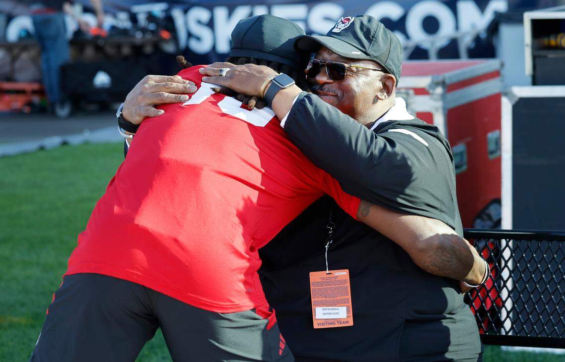 N.C. State’s Keyon Lesane (15) hugs special assistant to the head coach Ruffin McNeill before the Wolfpack’s’ game against UConn at Rentschler Field in East Hartford, Conn. Thursday, August 31, 2023.