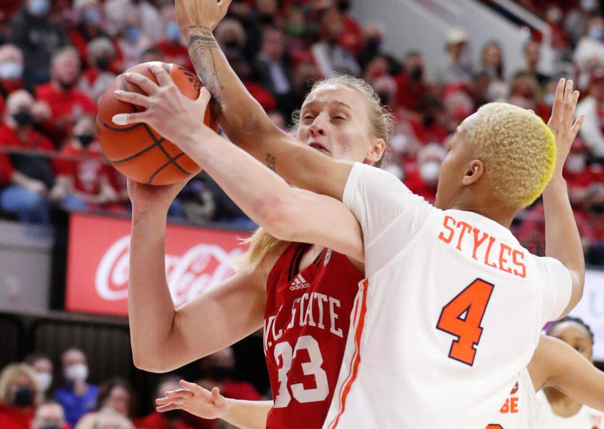 N.C. State’s Elissa Cunane (33) is fouled by Syracuse’s Alaysia Styles (4) during the first half of N.C. State’s game against Syracuse at Reynolds Coliseum in Raleigh, N.C., Sunday, Feb. 20, 2022.