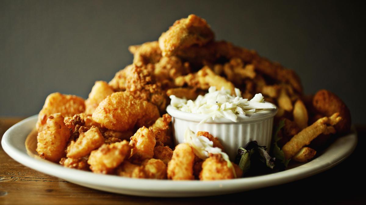 Cape Fear Seafood Company’s the Whole Boat combo was piled generously with fried shrimp, flounder, clams, scallops and oysters, served with fries, hush puppies, and creamy coleslaw.
