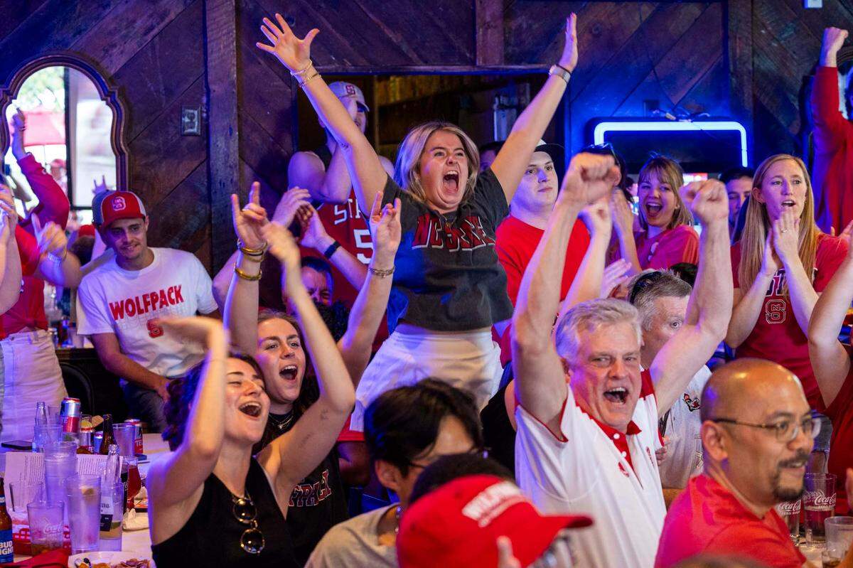 NC State fans at Players’ Retreat in Raleigh celebrate a Wolfpack lead against Duke during the second half of the Elite Eight round of the NCAA Men’s Division I Basketball Tournament on Sunday, March 31.