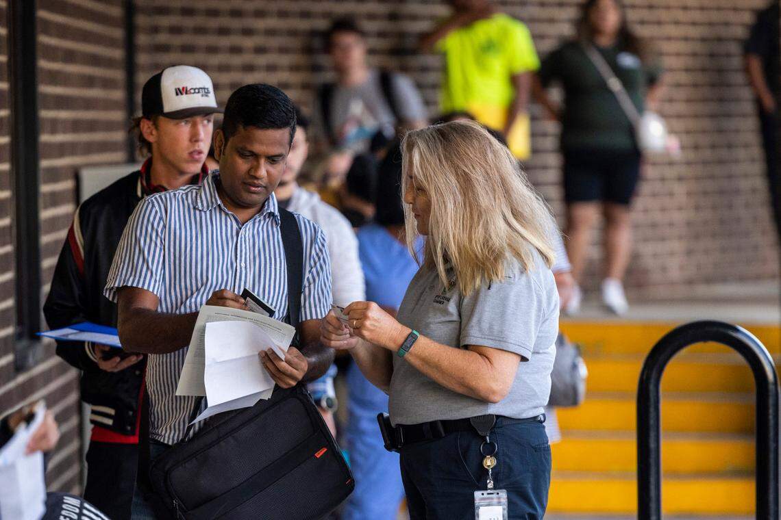 Drivers license examiner Sandra Barrett helps Gokul Annamalai make sure his documents are in order at the NC Department of Motor Vehicles’ West Raleigh Driver License Office Friday morning, Sept. 2, 2022.